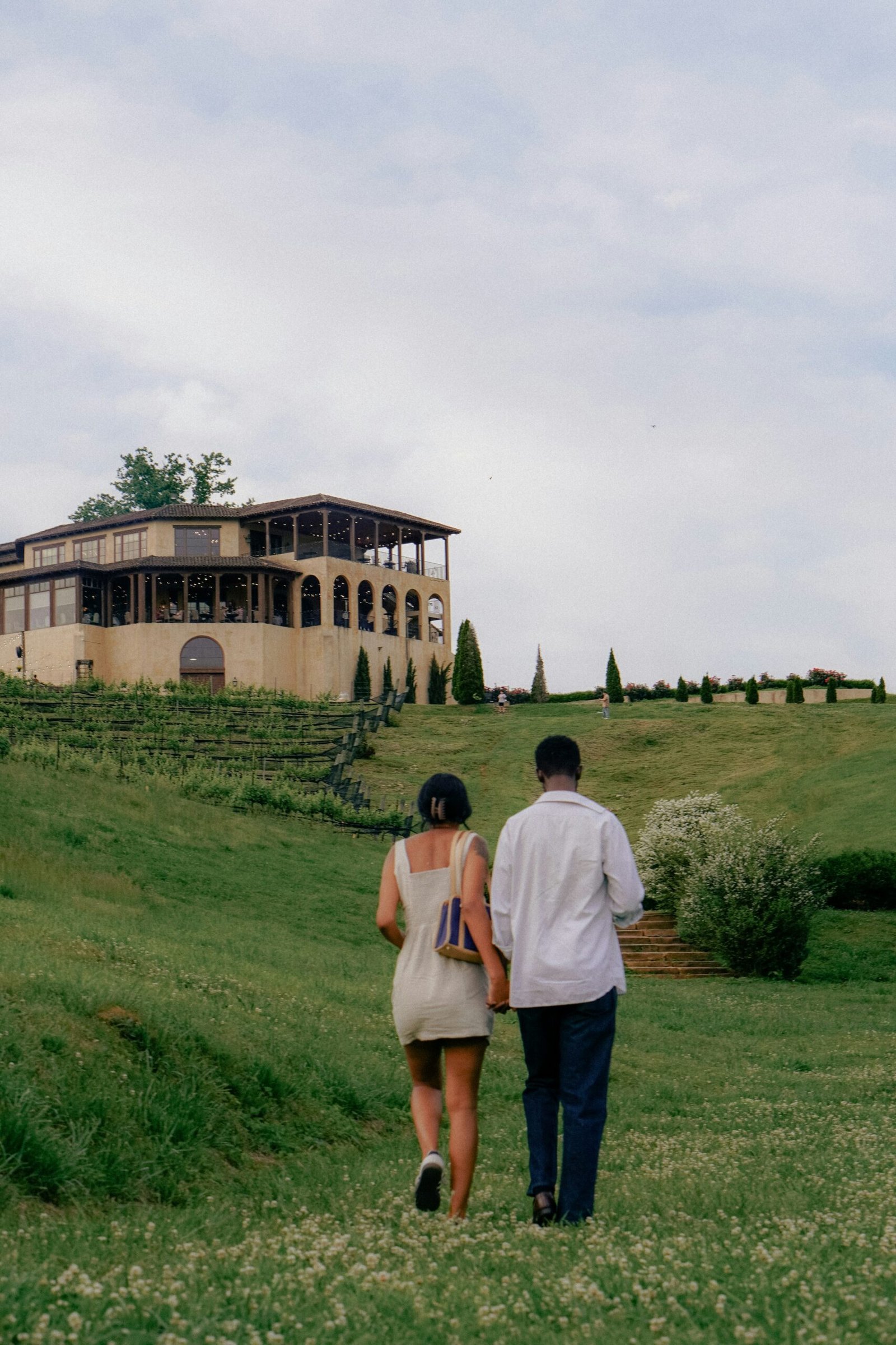 A man and a woman walking in a field